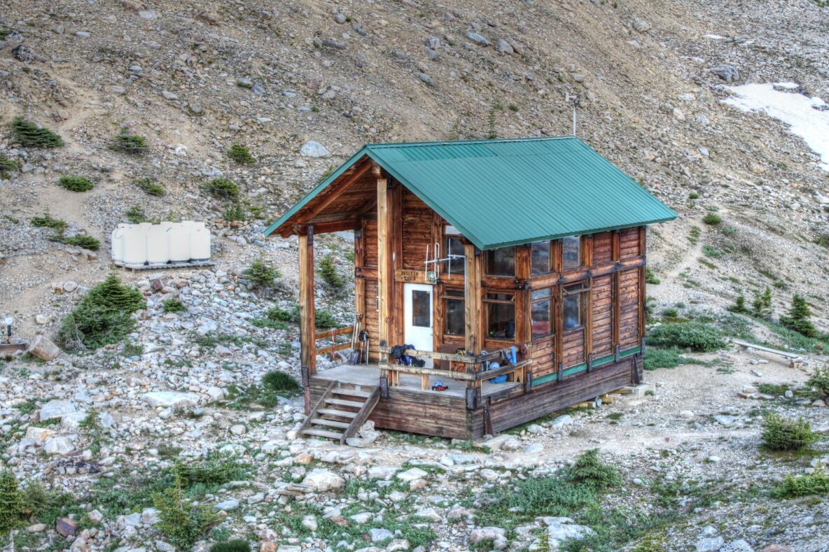 Asulkan Hut sits on a rocky outcrop in the Selkirk Mountains